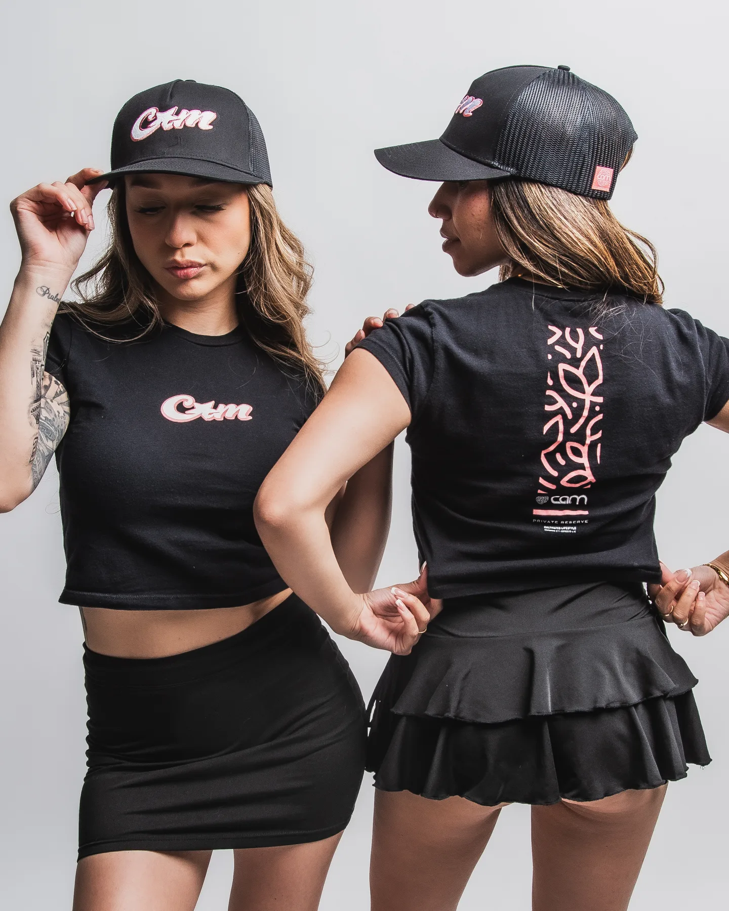 Front and back views of black CAM apparel and headwear