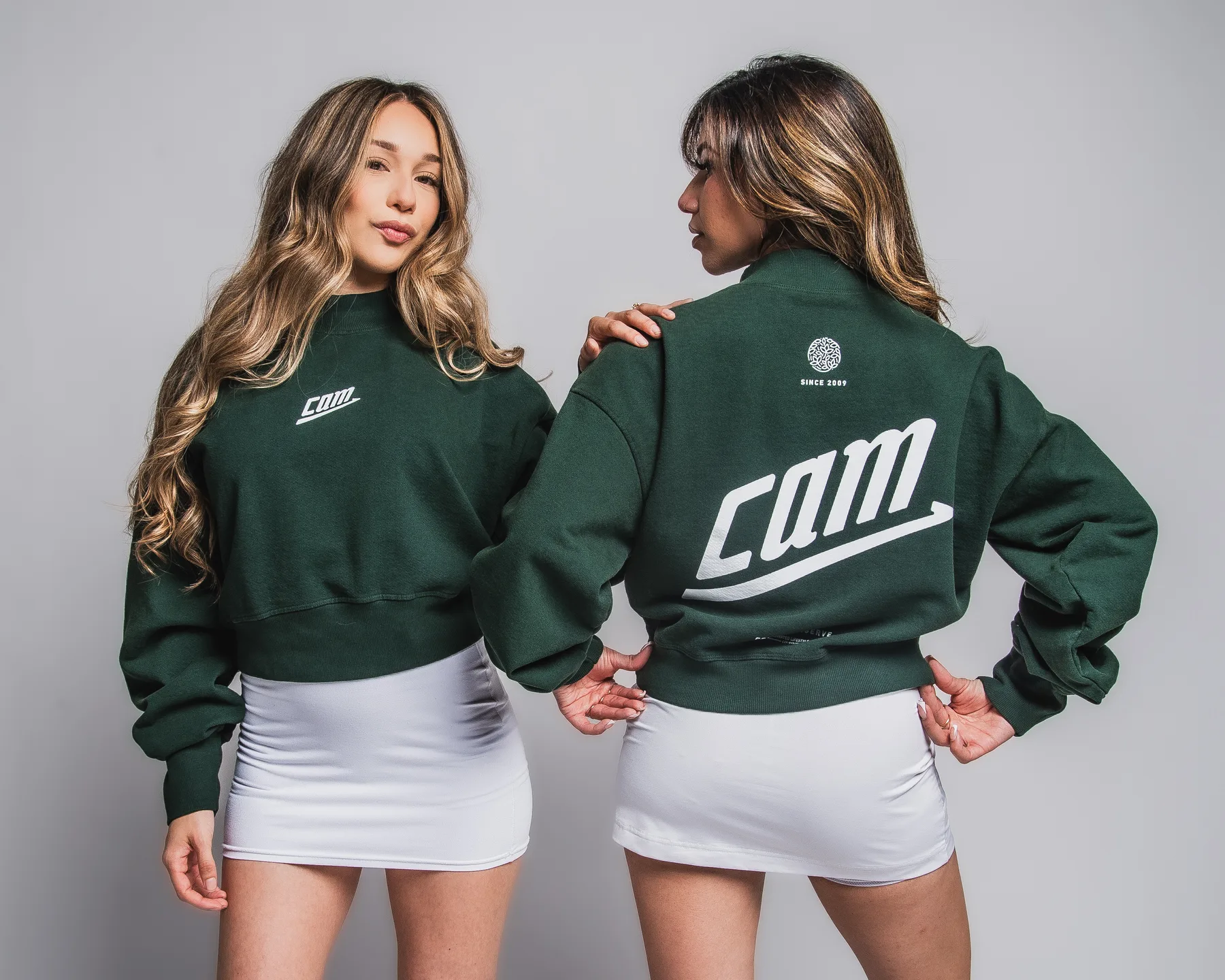 Front and back views of the green CAM crewneck
